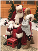 Little girl telling Santa Claus her wish list
